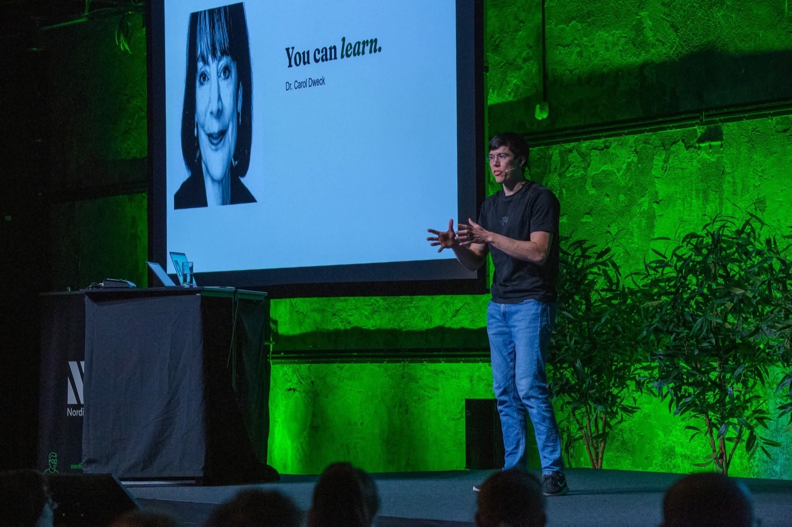 Jonas Hulthén on the green-lit Nordic Testing Days main stage in Tallinn, beside a slide that quotes Dr. Carol Dweck, you can learn