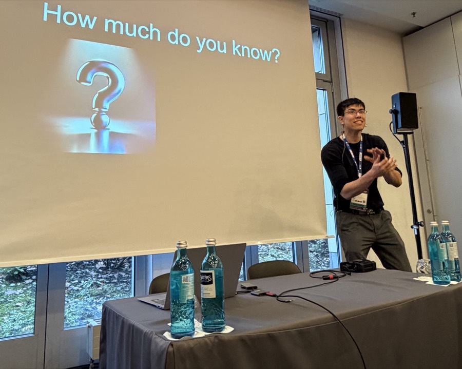 Jonas Hulthén speaking at the Agile Testing Days conference beside a slide asking 'How much do you know?'
